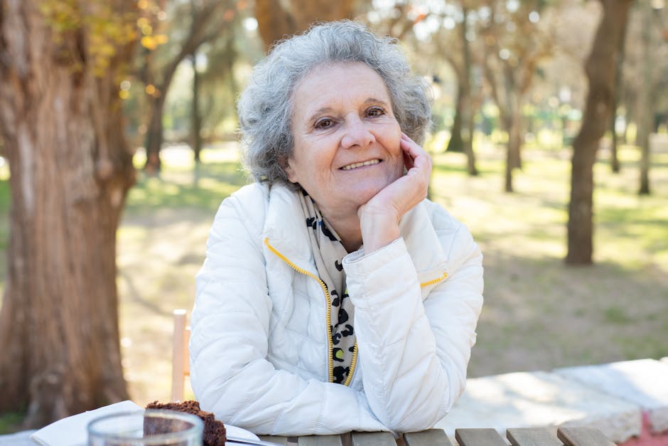 Smiling person sitting in a lotus pose, radiating a sense of well-being.